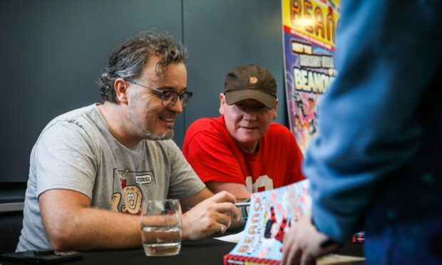 Beano editors Mike Stirling and Craig Graham during the book signing. Image: Mhairi Edwards/DC Thomson