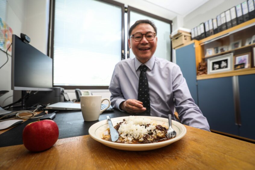 Professor Chim Lang enjoying his beef stew for lunch.