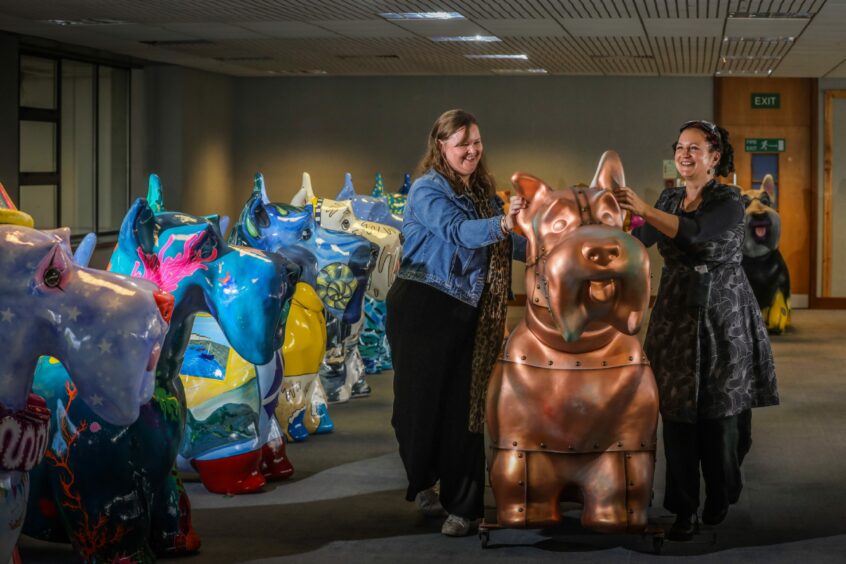 Project manager Jane Kennedy and artist co-ordinator Rio Moore with Copper Dog by John Fairley.