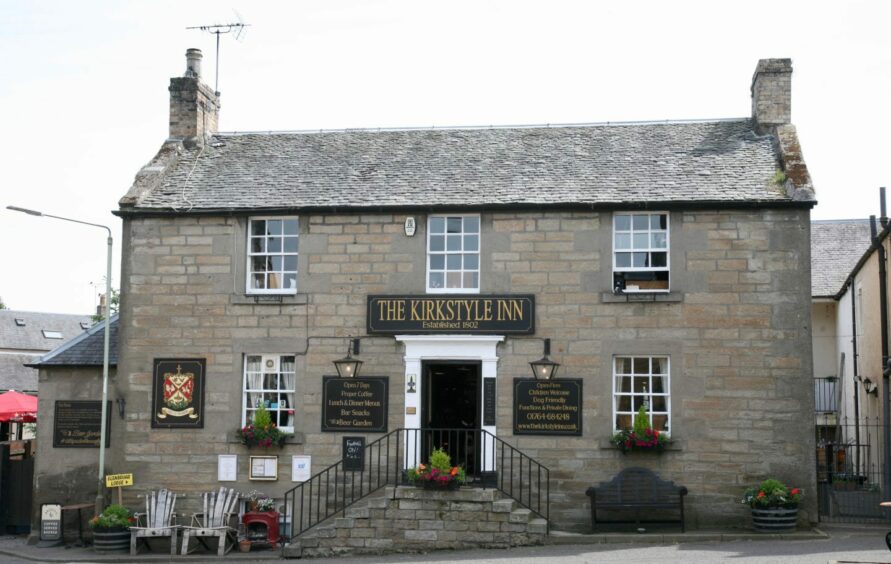 The inn is a two-storey building with steps leading up to its front door.