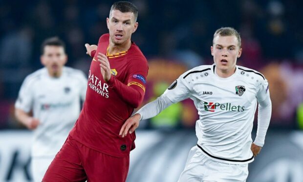 Roma's Edin Dzeko is tracked by St Johnstone trialist Sven Sprangler.