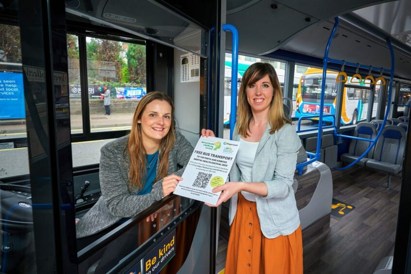 Sarah Elliot of Stagecoach and Roxanne Kerr of Trauma Healing Together, which is organising the Perth and Kinross Mental Health and Wellbeing Festival. The pair are inside a Stagecoach bus with Sarah in the driver's seat.