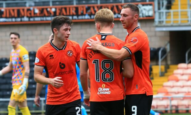 Declan Glass and Kai Fotheringham celebrate with Louis Moult as United beat Dunfermline.