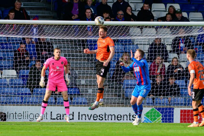 Kevin Holt wins one of numerous aerial challenges for Dundee United