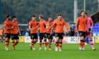 Delirious Dundee United players go to take the acclaim of the travelling fans