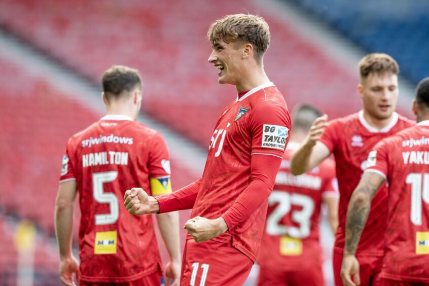 Lewis McCann celebrates after scoring a double versus Queen's Park. Image: Craig Brown/DAFC.