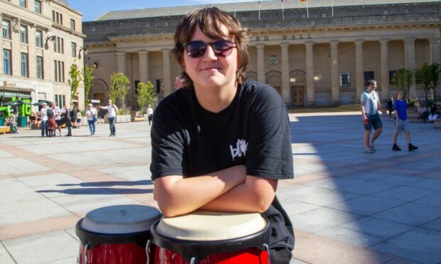 Olivia with drums in City Square during Dundee schools rehearsal for Wurzburg festival.