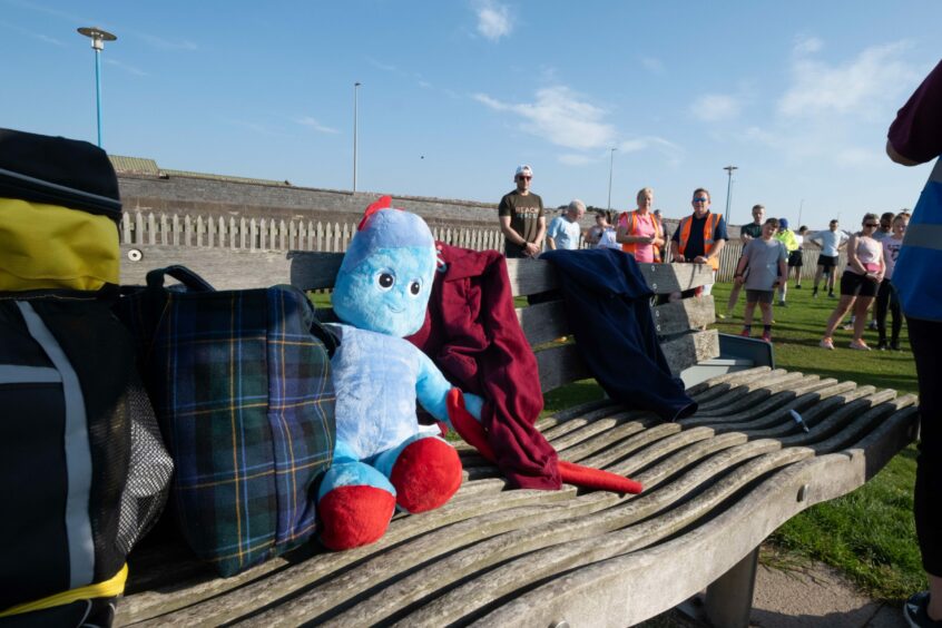 Participants' belongings on a bench during the parkrun