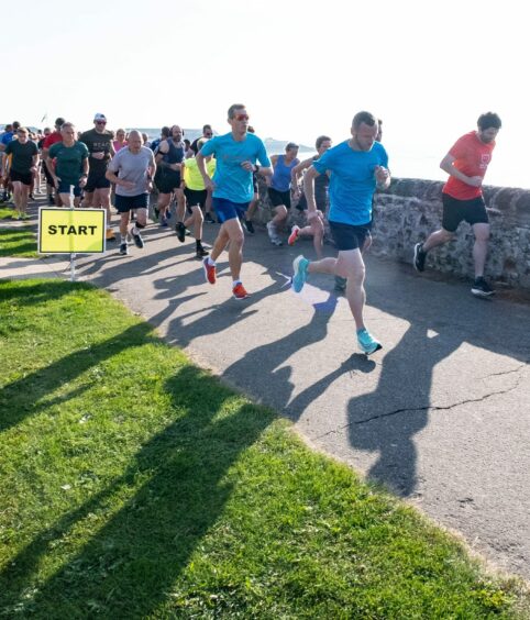 People running during West Links parkrun in Arbroath.
