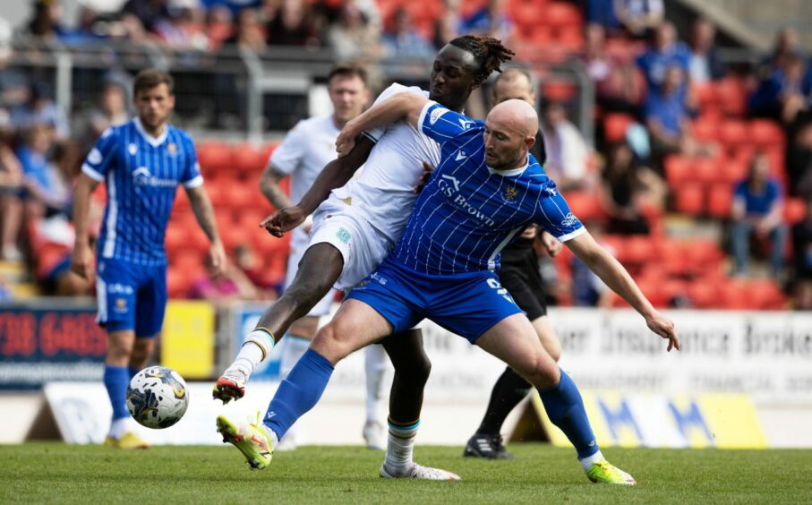 Chris Kane back in the St Johnstone FC team making his presence felt in a tackle.