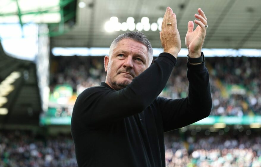 Tony Docherty applauds the away support at Celtic Park. Image: SNS