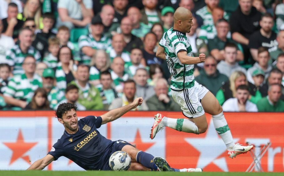 Lamie tackles Celtic forward Daizen Maeda. Image: SNS
