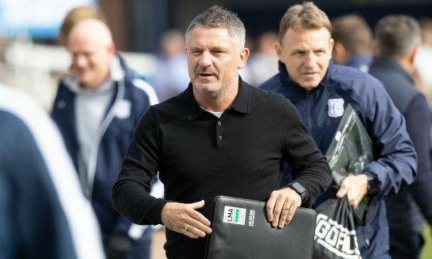 Dundee boss Tony Docherty on the sidelines carrying a folder