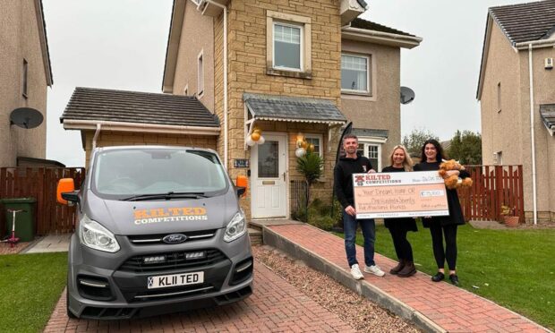 Katie Barker (middle) with brother Kevin and sister-in-law Lucy outside the Montrose house being put up for raffle in the competition