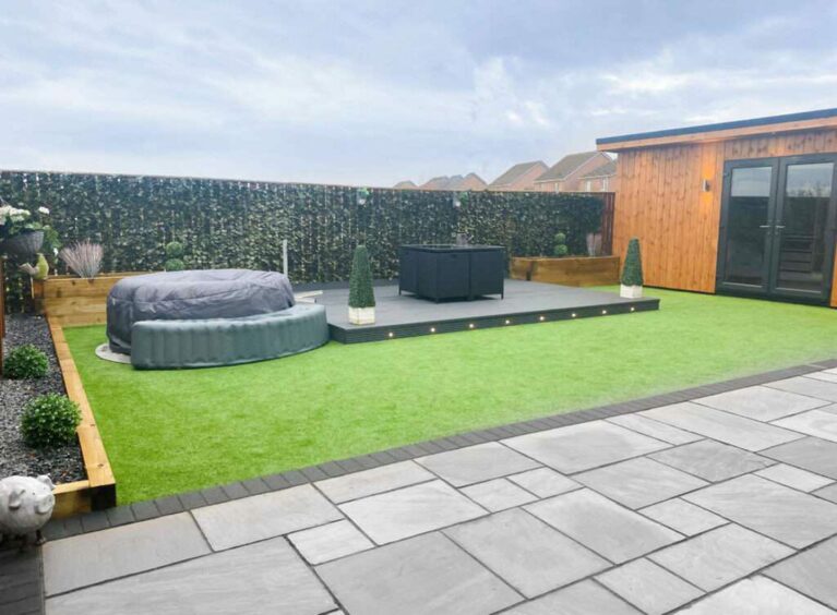 The back garden area of the Montrose house being put up for raffle in the online competition, including astroturf, a decking area and a hot tub