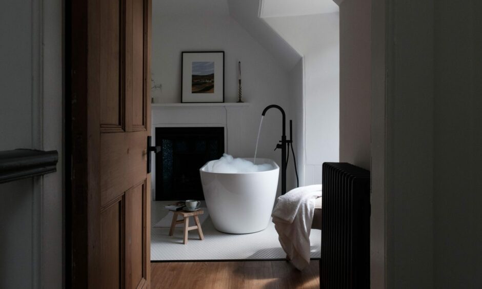 One of the bedrooms with a freestanding bathtub at The Farmhouse at Ballintaggart.