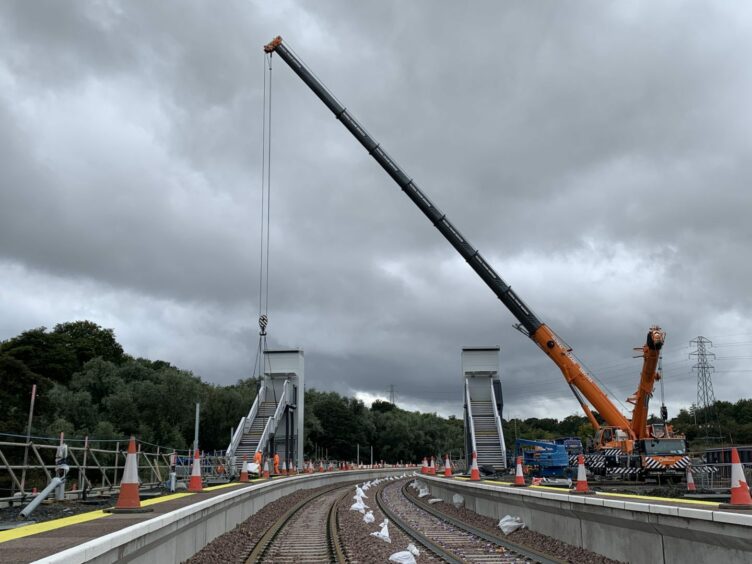 The footbridge being lifted into place as part of the Levenmouth Rail link.