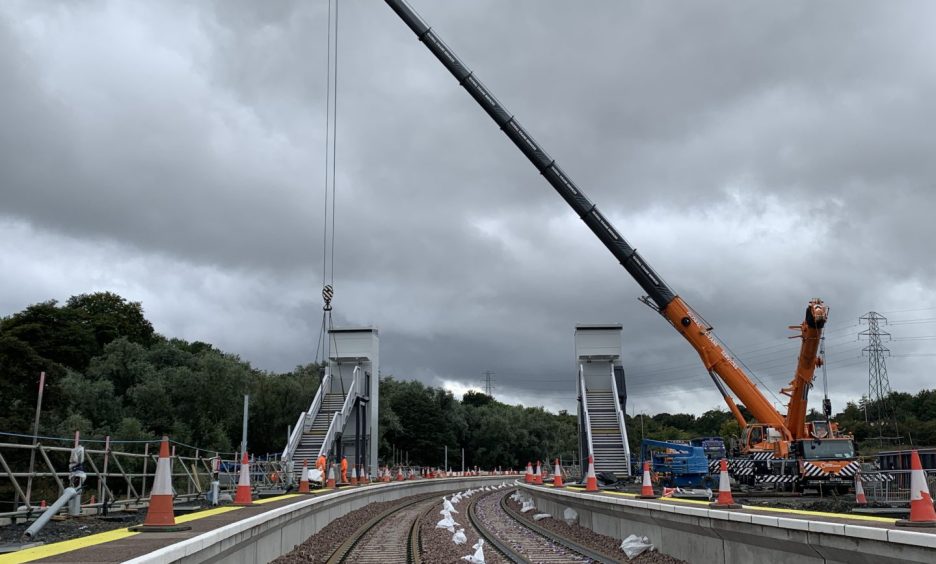 The footbridge being lifted into place as part of the Levenmouth Rail link.