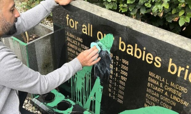 A number of locals turned up to help clean off the paint from the memorial stones.