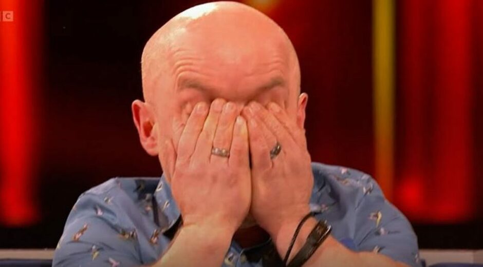 Colin Brown from Kirkcaldy in Fife wipes away tears after winning on The Wheel