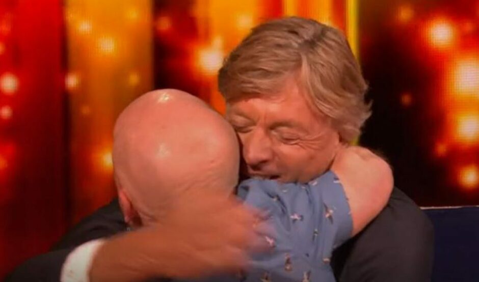 Colin Brown from Kirkcaldy in Fife hugs Richard Madeley after winning The Wheel