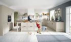 Father and son in a new fitted kitchen.