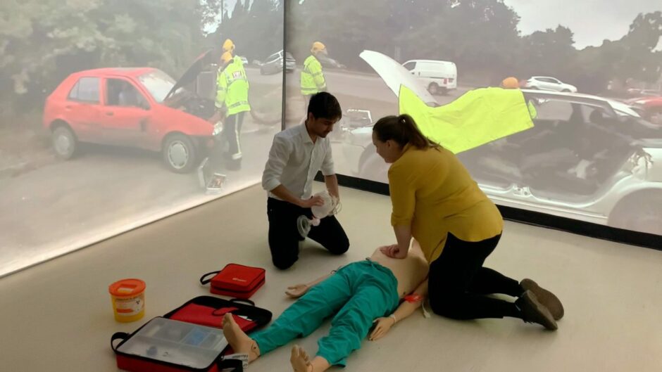 participants learn CPR in the University of Dundee's immersion room