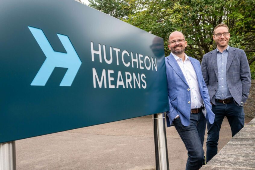 Hutcheon Mearns managing directors Craig Hutcheon and Adam Maitland outside the Hutcheon Mearns Aberdeen office sign.