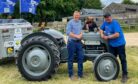 Pete Burdass with Countryfile presenter Adam Henson standing next to his vintage Massey Ferguson tractor.