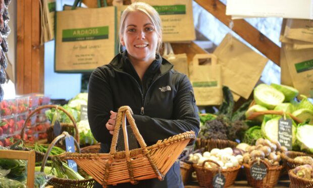 A woman holding a basket inside Ardross Farm Shop in Fife