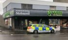 Police outside Greens of Dundee on Albert Street in Stobswell after the latest break-in