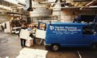 Staff members loading materials into the back of the van at Tayside Plumbing Supplies in 1997. Image: DC Thomson.