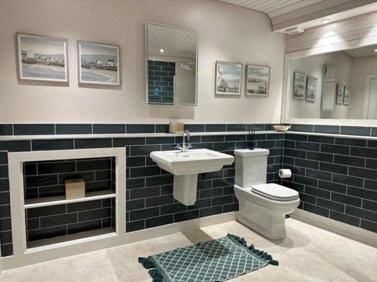 The large family bathroom with brickwork-effect tiles at the St Andrews flat