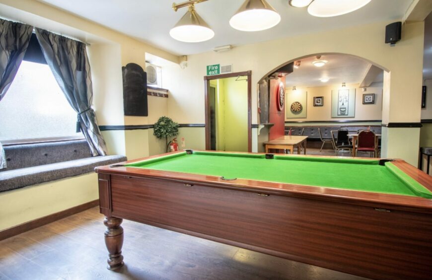 The entrance to the Park Bar in Brechin and a pool table