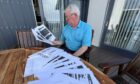 Former Arbroath RNLI ops manager Alex Smith with the heavily redacted material. Image: Graham Brown/DC Thomson