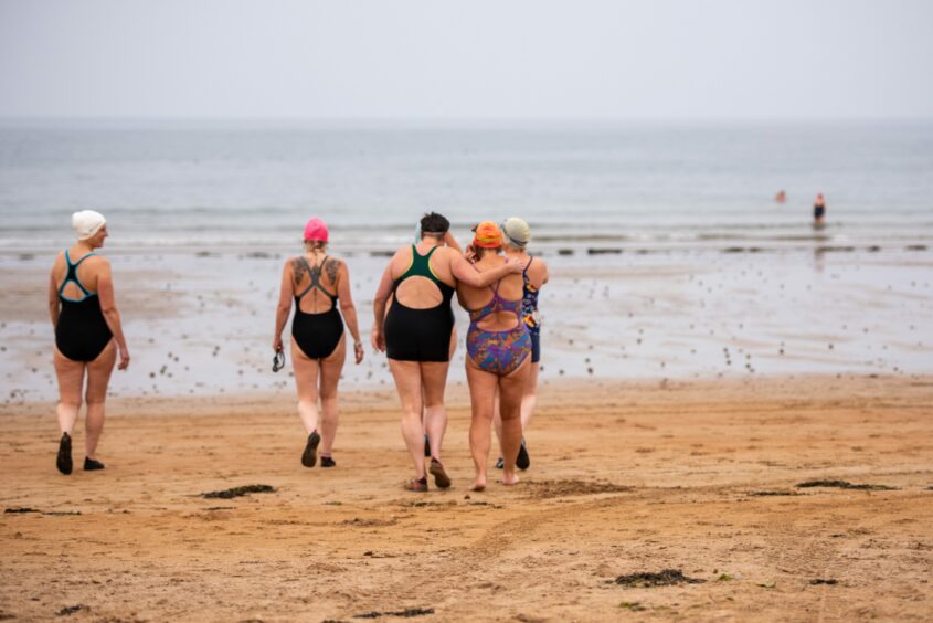 Holly Wilde and some of her friends from St Andrews Swimmers head for a wild swim at East Sands, St Andrews.
