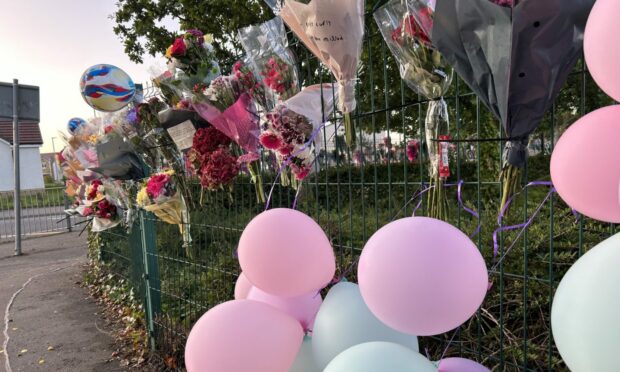 Flowers and balloons on the fence at Inverkeithing High School following the pupil's death