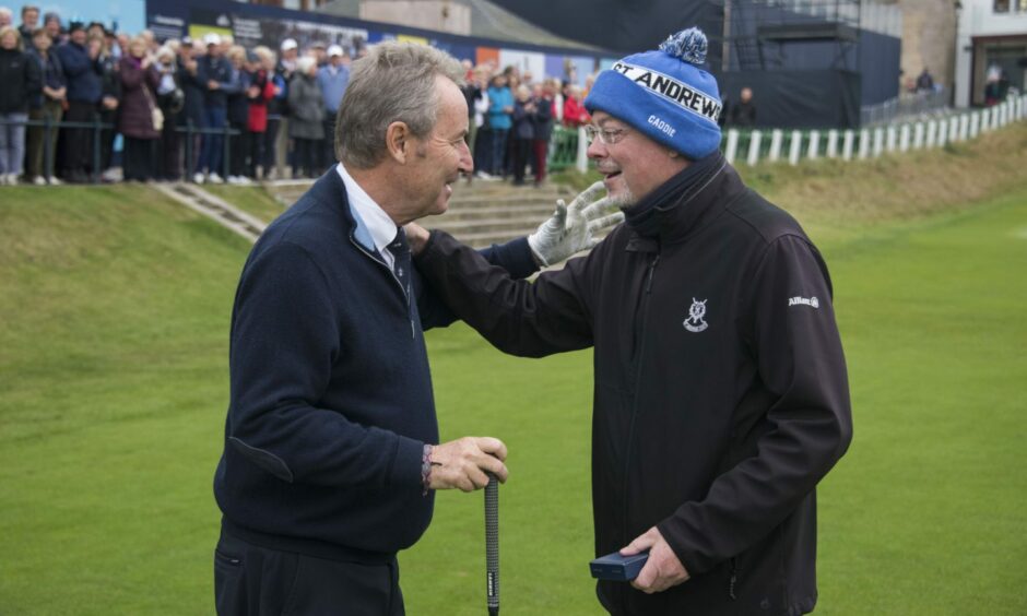 New R&A captain Mr Donaldson, left, presents a gold sovereign to Mr Clark. 