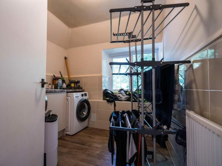 The utility room is just off the kitchen at the four bed home. 