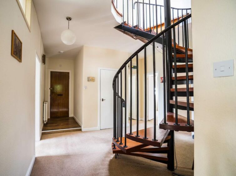 Well-finished spiral staircase leads to the second floor in the four bed family home. 