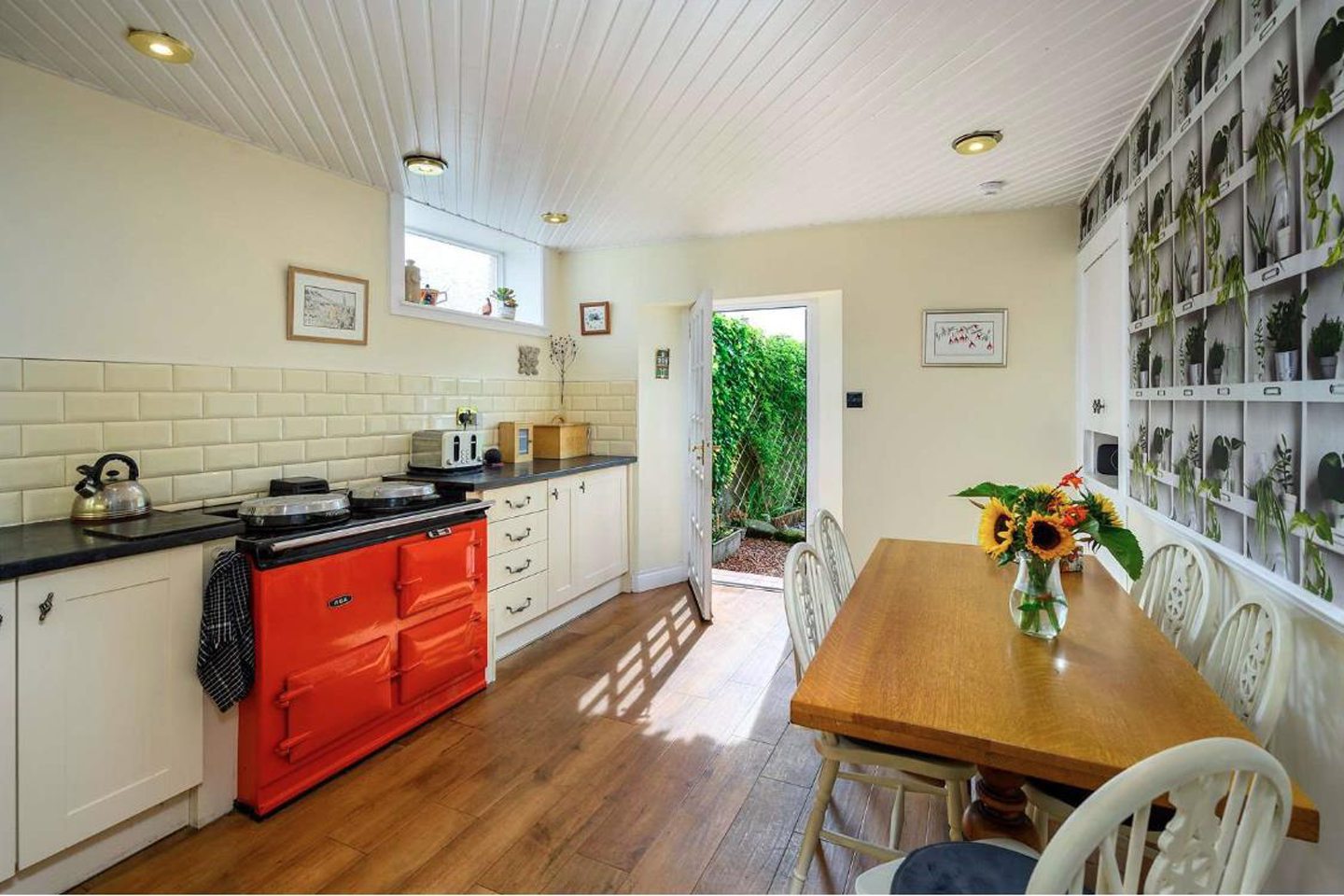 The kitchen which features a red Aga oven