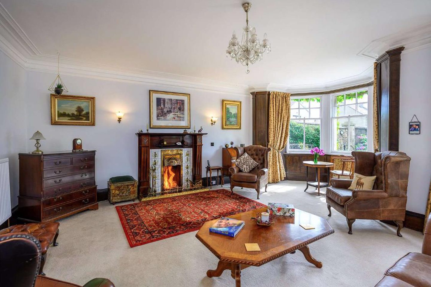 Park House living room with a fire place and bay-windows