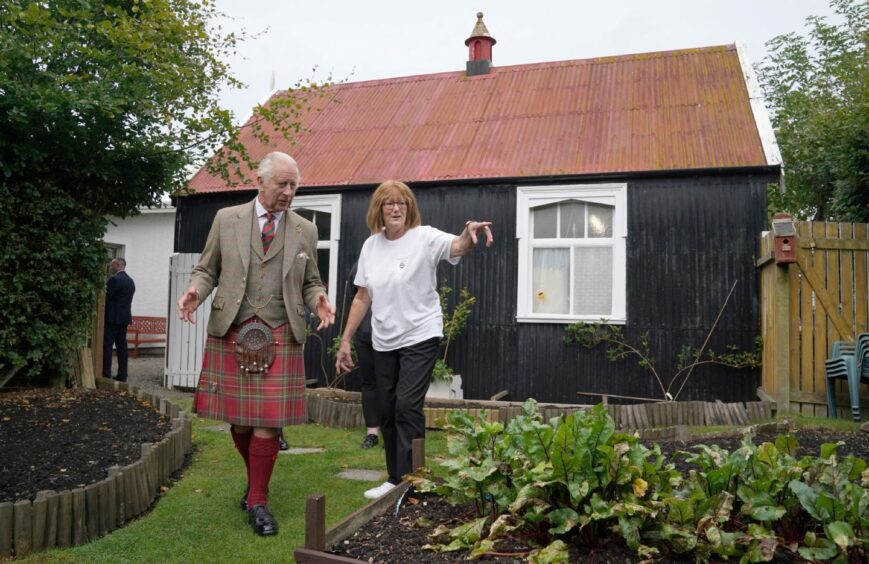 Susan Mitchell shows King Charles round the gardens of Broke not Broken food bank at St Paul's Episcopal Church in Kinross