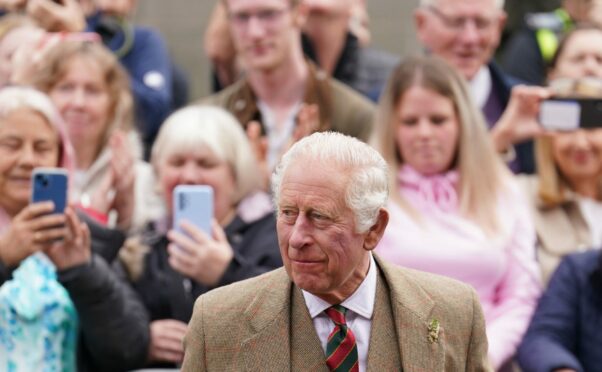 Prince Charles being filmed my members of the public on mobile phones.