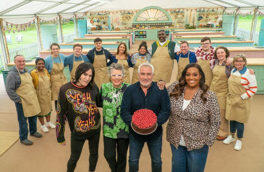 the Great British Bake Off contestants line up.
