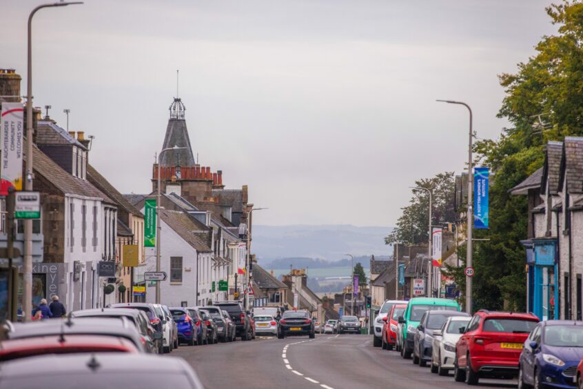 Auchterarder High Street stretching east with the Perthshire countryside in the distance.