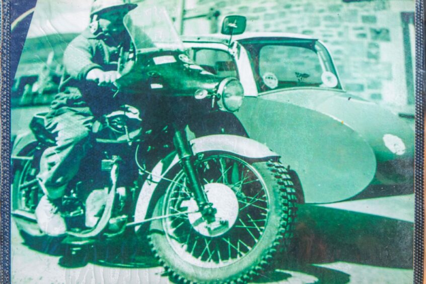 Black and white photo of Davie McLean riding a BSA motorbike