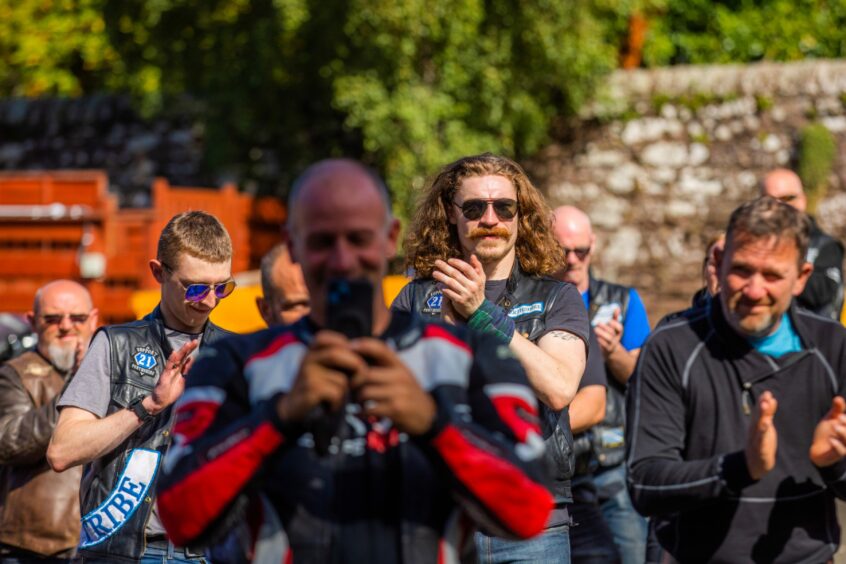 Bikers applauding and filming on mobile phones at the Birches care home, Crieff.