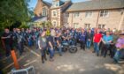Large group of bikers in the grounds of the Birches care home, Crieff, with Helen Maclellan and John Neilson in front.