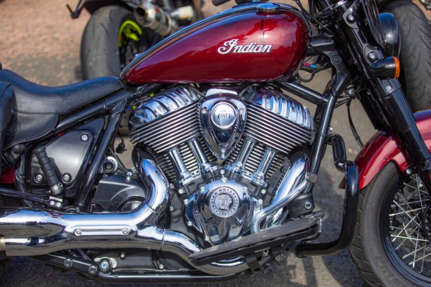 Close up of shiny motorcycle with 'Indian' logo.